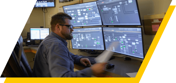 Kinetik employee working in the control room at the Pecos facility