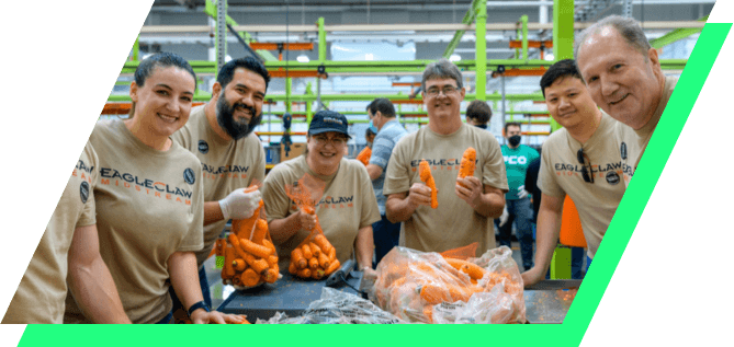 Group shot of Kinetik employees volunteering at a Houston food bank
